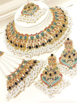 Ornate necklace and earrings set on a white background